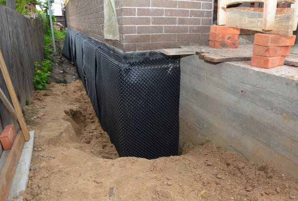 SJ Waterproofing Pros technician performing targeted Emergency Waterproofing assessment in Rensselaer, IN